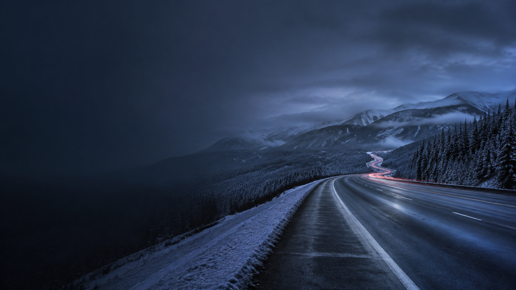 Snow-lined mountain road at dusk